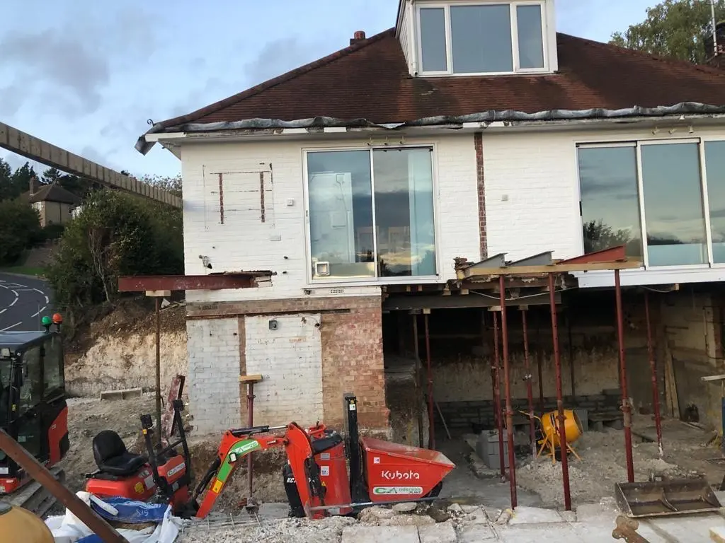 Hillside house with structural work in progress